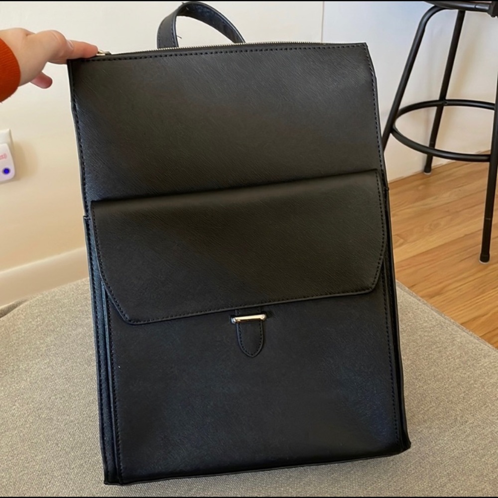 Samsonite black leather backpack with adjustable back straps.